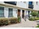 Close-up of townhome entrances with manicured shrubs, creating an inviting and well-maintained facade at 220 S Summerlin Ave, Orlando, FL 32801