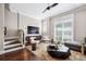 Inviting living room with a modern TV, stylish furniture, and elegant staircase at 220 S Summerlin Ave, Orlando, FL 32801