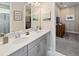 Bathroom with double sink vanity, light countertops, and decorative mirrors above the counter at 2332 Salty Winds Way, Kissimmee, FL 34747