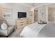Cozy bedroom with a modern dresser and sleek TV, offering style and functionality at 2332 Salty Winds Way, Kissimmee, FL 34747