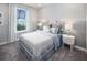 Bright bedroom featuring a decorative headboard, plush bedding, and large window for natural light at 2332 Salty Winds Way, Kissimmee, FL 34747