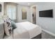 Serene bedroom with a large window, closet and soft decor, perfect for relaxation at 2332 Salty Winds Way, Kissimmee, FL 34747