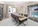 Bright dining room featuring a modern chandelier and a large window overlooking the pool area at 2332 Salty Winds Way, Kissimmee, FL 34747