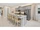 Well-equipped kitchen featuring an oversized island, stainless appliances and grey cabinetry at 2332 Salty Winds Way, Kissimmee, FL 34747