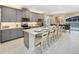 Stunning kitchen features an oversized island, stainless appliances and modern grey cabinetry at 2332 Salty Winds Way, Kissimmee, FL 34747