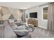 Inviting living room with a large sectional, modern wall art, and abundant natural light at 2332 Salty Winds Way, Kissimmee, FL 34747