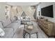 Spacious living room features comfortable seating, modern decor, and a large screen TV at 2332 Salty Winds Way, Kissimmee, FL 34747