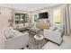 Cozy living room featuring a media center and windows at 2332 Salty Winds Way, Kissimmee, FL 34747