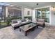 Inviting screened-in patio featuring comfortable seating, a glass table, and neutral decor at 2332 Salty Winds Way, Kissimmee, FL 34747