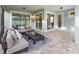 Inviting screened-in patio featuring comfortable seating, a glass table, and neutral decor at 2332 Salty Winds Way, Kissimmee, FL 34747