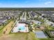 Aerial view showcases a pool, playground, parking lot, and lush landscaping at 2614 Mead Ave, St Cloud, FL 34771