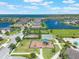 Community aerial view showcases a lake, playground, pool, and lush landscaping at 2614 Mead Ave, St Cloud, FL 34771