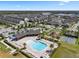 Aerial view showcases a pool, playground, parking lot, and lush landscaping at 2614 Mead Ave, St Cloud, FL 34771