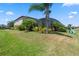 Expansive backyard featuring lush landscaping, a screened in patio, and plenty of green space at 2614 Mead Ave, St Cloud, FL 34771