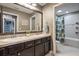 Bathroom featuring double sinks, dark cabinetry, and a shower/bath combo at 2614 Mead Ave, St Cloud, FL 34771