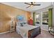Comfortable bedroom featuring a ceiling fan, two windows, and stylish decor at 2614 Mead Ave, St Cloud, FL 34771
