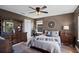 Comfortable bedroom featuring hardwood floors, decorative mirror, and a ceiling fan at 2614 Mead Ave, St Cloud, FL 34771