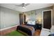 Cozy bedroom features a ceiling fan, wood floors, and decorative hanging plants at 2614 Mead Ave, St Cloud, FL 34771