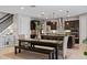 Bright dining area with modern table and seating, seamlessly connected to the kitchen and staircase at 2614 Mead Ave, St Cloud, FL 34771