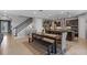 Open dining area adjacent to the kitchen, featuring a modern farmhouse table, bench seating and wrought iron stair railing at 2614 Mead Ave, St Cloud, FL 34771