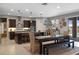 Open-concept dining area with modern lighting, dark wood cabinets and a seamless transition to the kitchen space at 2614 Mead Ave, St Cloud, FL 34771