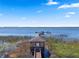 Picturesque lakeside dock with gazebo and boat access under a blue sky at 2614 Mead Ave, St Cloud, FL 34771