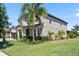 Charming two-story home featuring a landscaped yard and covered front porch at 2614 Mead Ave, St Cloud, FL 34771