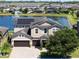 Aerial view of a beautiful two-story home with solar panels, a three-car garage, and a scenic pond at 2614 Mead Ave, St Cloud, FL 34771