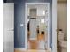 Hallway showing a view into another room with hardwood floors and an ensuite bathroom at 2614 Mead Ave, St Cloud, FL 34771