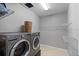 Well-lit laundry room with modern washer, dryer, and wire shelving at 2614 Mead Ave, St Cloud, FL 34771