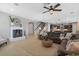 Spacious living room with fireplace, ceiling fan and an open layout with views of the staircase and kitchen at 2614 Mead Ave, St Cloud, FL 34771
