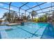 Beautiful screened pool with waterfall feature surrounded by lush tropical landscaping at 2614 Mead Ave, St Cloud, FL 34771