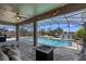 Screened in pool area with a covered patio, comfortable seating, and fire pit at 2614 Mead Ave, St Cloud, FL 34771