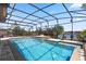 Inviting screened pool with built-in spa and waterfront view at 2614 Mead Ave, St Cloud, FL 34771