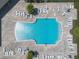 Aerial view of sparkling community pool with abundant lounge chairs, tables, and lush landscaping at 2614 Mead Ave, St Cloud, FL 34771