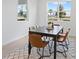 Cozy dining area with a modern table and seating for six, with natural light at 2770 Sweet Acacia Dr, Clermont, FL 34711