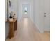 Bright and airy hallway with neutral walls, wood look tile flooring, and natural light at 2770 Sweet Acacia Dr, Clermont, FL 34711