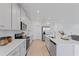 Contemporary kitchen featuring white cabinets, stainless steel appliances, and a subway tile backsplash at 2770 Sweet Acacia Dr, Clermont, FL 34711