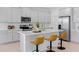Modern kitchen with white cabinetry, stainless steel appliances, and a large center island at 2770 Sweet Acacia Dr, Clermont, FL 34711