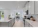 Bright, open kitchen with white cabinets, a stainless steel sink and oven, and tile floors at 2770 Sweet Acacia Dr, Clermont, FL 34711