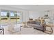 Open-concept living area with stylish furnishings, tile flooring, and a large sliding glass door at 2770 Sweet Acacia Dr, Clermont, FL 34711