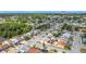 Expansive aerial view of a residential community showcasing mature trees and a scenic pond at 2803 Charing Cross Way, Orlando, FL 32837