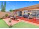 Back yard with a patio, artificial turf, outdoor kitchen, BBQ and small outdoor furniture at 2803 Charing Cross Way, Orlando, FL 32837