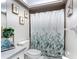 Bathroom featuring a botanical-themed shower curtain, modern decor, and stylish vanity at 2803 Charing Cross Way, Orlando, FL 32837