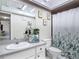 Bathroom with modern vanity, botanical decor, and a shower with a leafy curtain at 2803 Charing Cross Way, Orlando, FL 32837