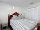 Bedroom features a wooden bed frame, closet, and neutral decor at 2803 Charing Cross Way, Orlando, FL 32837