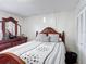 Bedroom with wood furniture, decorative mirror, and patterned bedding at 2803 Charing Cross Way, Orlando, FL 32837
