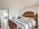 A bedroom featuring a decorative bed frame, and a view into an adjacent room at 2803 Charing Cross Way, Orlando, FL 32837