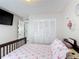 Bedroom with a view of an ensuite bathroom, closet, and decorative accents at 2803 Charing Cross Way, Orlando, FL 32837