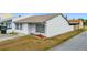 Charming home featuring white stucco, neutral roof, tidy front yard, and welcome decor at 2803 Charing Cross Way, Orlando, FL 32837